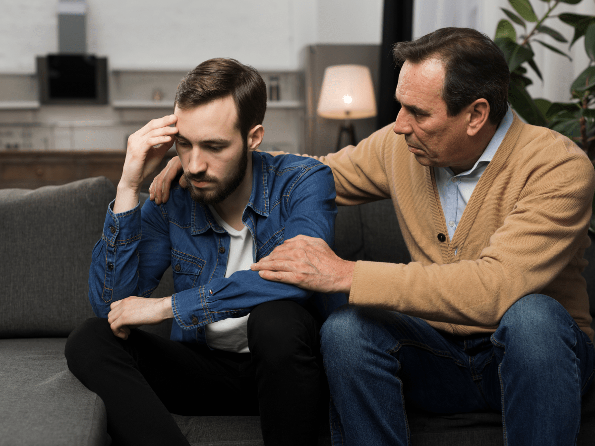 father comforting adult son